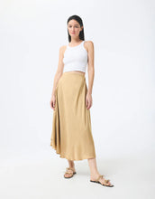 Load image into Gallery viewer, Model wearing Leo &amp; Ugo Malia Satin Skirt in Beige.
