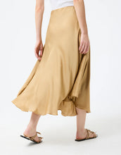 Load image into Gallery viewer, Model wearing Leo &amp; Ugo Malia Satin Skirt in Beige - back.
