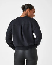 Load image into Gallery viewer, Model wearing Spanx - Air Essentials Crew in black - back.
