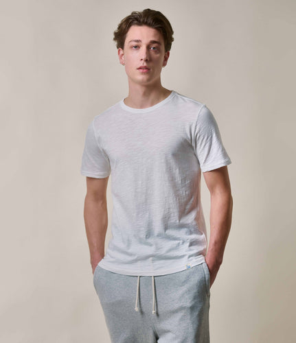 Model wearing Merz B. Schwanen - Good Basics Unisex T-shirt in White.