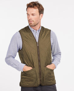 Model wearing Barbour Polarquilt Waistcoat Zip-In Liner in Olive.