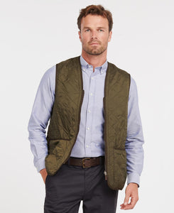 Model wearing Barbour Polarquilt Waistcoat Zip-In Liner in Olive.