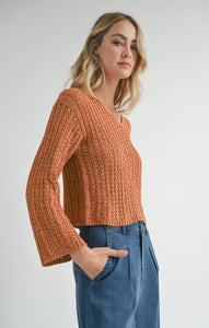 Model wearing Sadie & Sage Perfect Flow Pointelle Knit Sweater in Pumpkin.