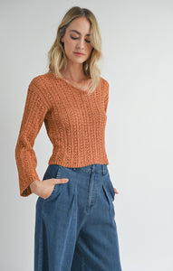 Model wearing Sadie & Sage Perfect Flow Pointelle Knit Sweater in Pumpkin.