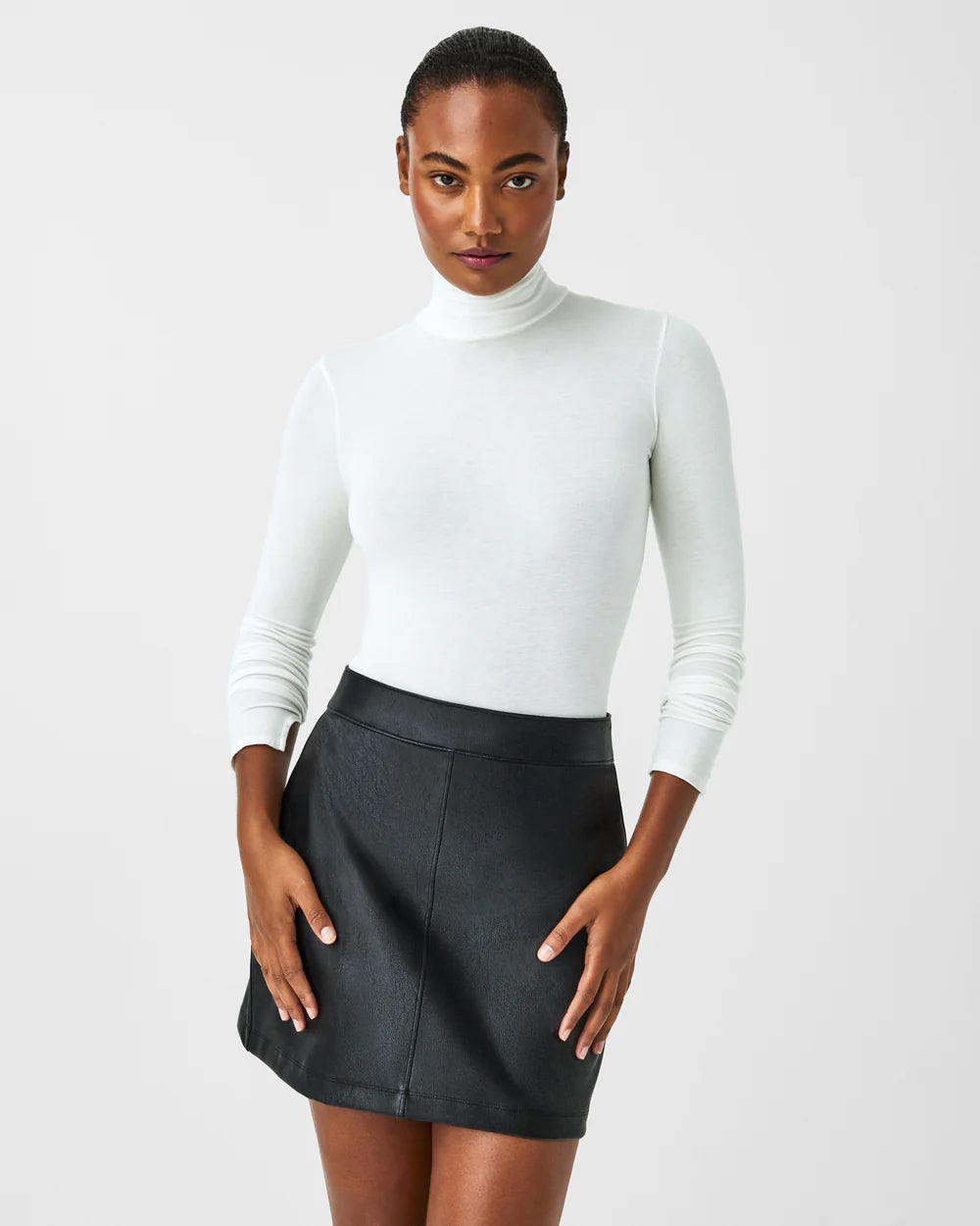 Model wearing Spanx - Long Sleeve Turtleneck in Powder.