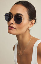 Load image into Gallery viewer, Model wearing ZSupply Highway Sunglasses in Gold - Grey Polarized.
