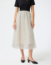 Load image into Gallery viewer, Model wearing Leo &amp; Ugo Etta Tulle Polka Dot Skirt in off white/black.
