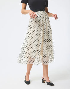 Model wearing Leo & Ugo Etta Tulle Polka Dot Skirt in off white/black.