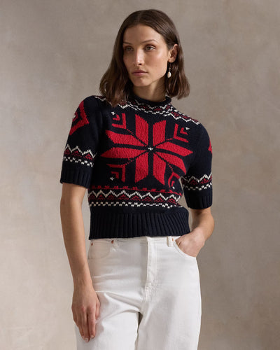 Model wearing Polo Ralph Lauren - Snowflake-Motif S/S Sweater in Navy/Red Multi.